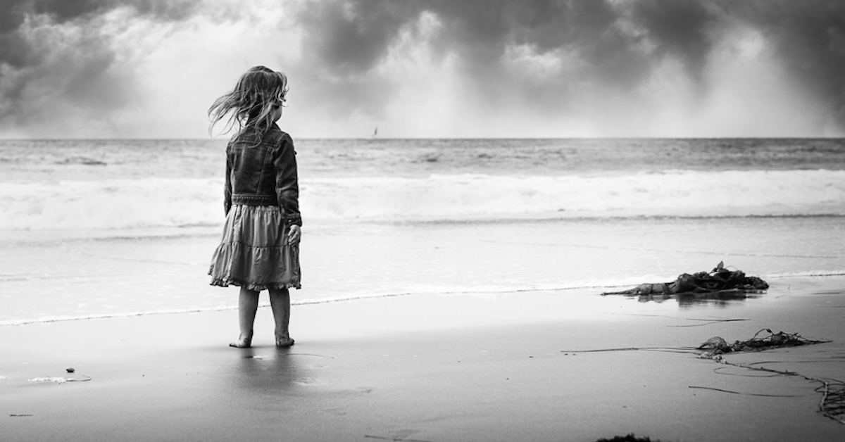 Girl-Standing-on-Beach-with-Wind-Blowing-through-her-Hair-by-Photographer-Gina-Yeo_jpg.png